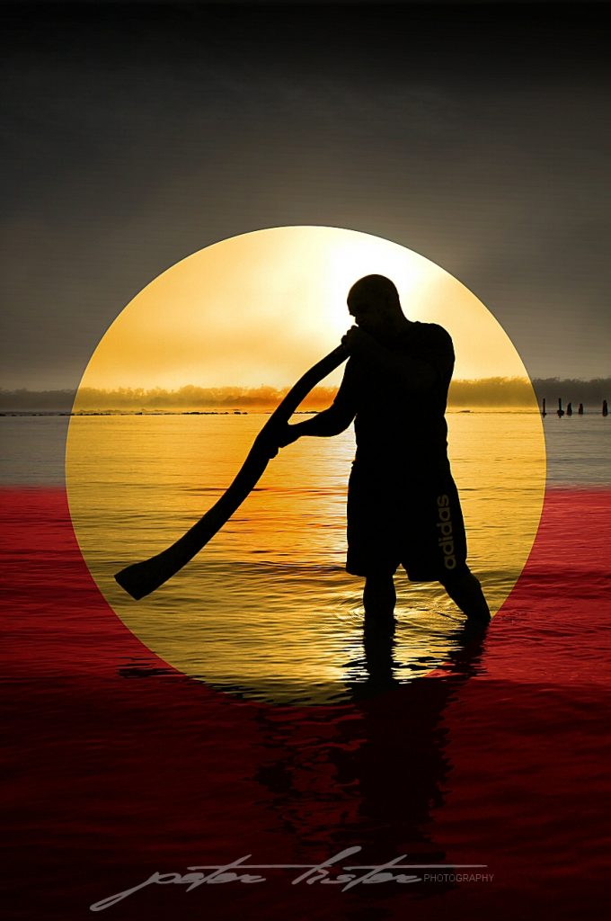 Aboriginal Playing Didgeridoo at Sunrise