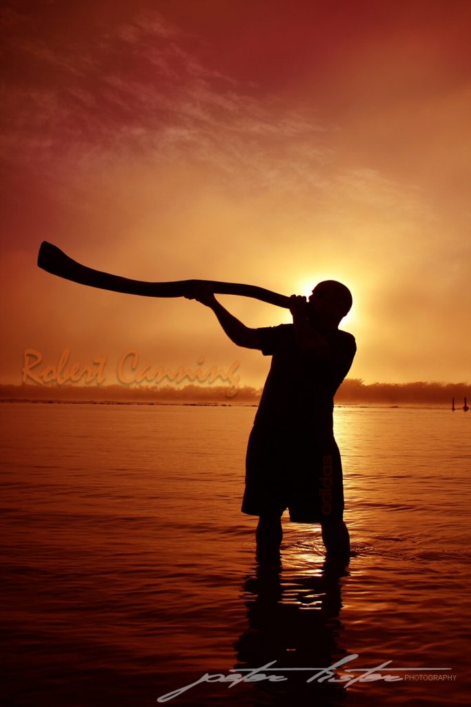 Aboriginal Playing Didgeridoo at Sunrise Urunga NSW Australia